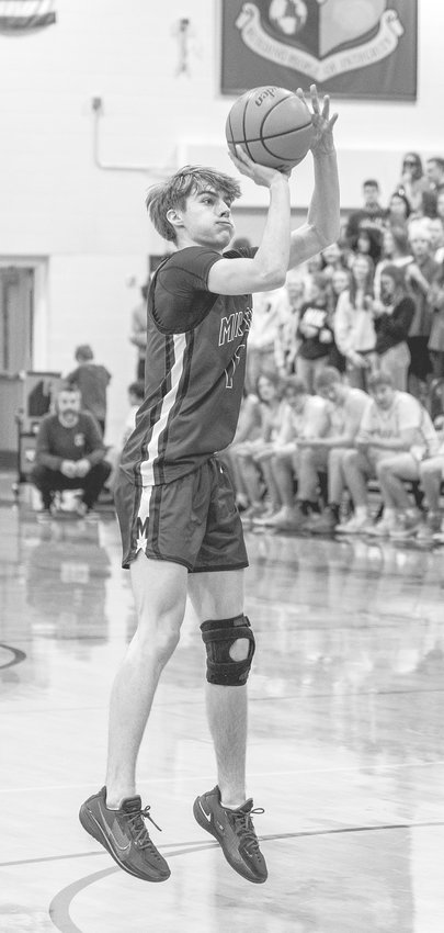 Micah Hartwig of Milford takes a shot against Ogallala in the district final Feb. 26.