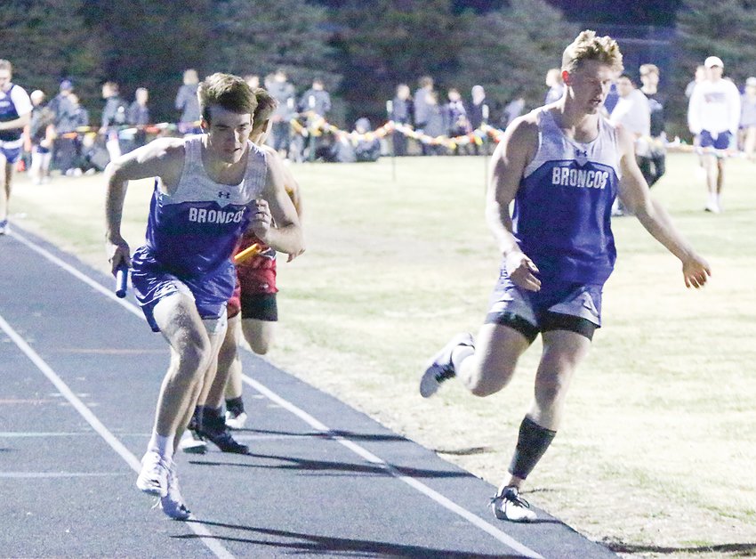 John Fehlhafer of Centennial starts his leg of the 4x400-meter relay March 29 as Jake Bargen leaves the track after handing off the baton.