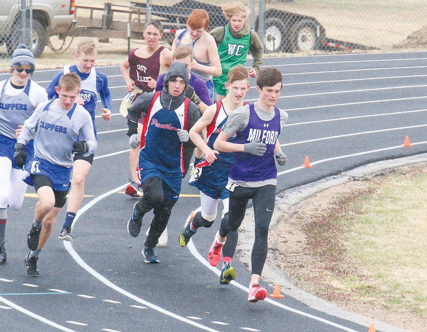 Kaleb Eickhoff of Milford leads the pack around the corner in the 3,200-meter run April 6 at Malcolm. Eickhoff was the race winner.