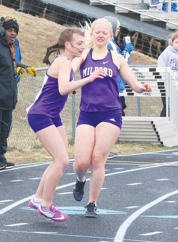 Myranda Schildt hands off to teammate Abby Svik in the 4x400-meter relay April 6 at Malcolm.