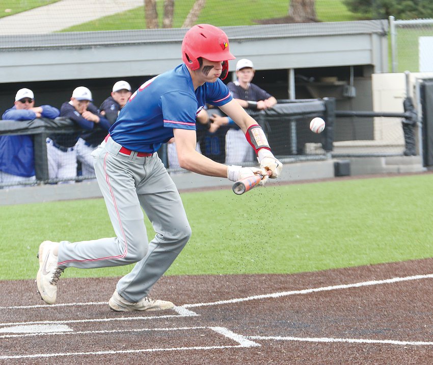 Colton Homolka of Crete/Milford attempts a bunt against Plattsmouth in the first round of district play May 6.