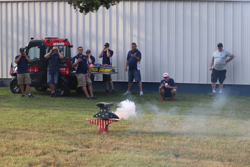Attendees watch the anvil firing, one of the earliest Seward July 4 events