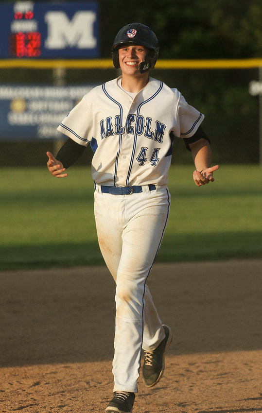 Malcolm's Luke Schmidt is all smiles after his home run against Palmyra in junior legion distrct action.