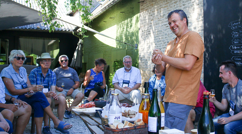 Olivier Billy laughs at a question as, from left, Trudy and Jeff Hines, Wayne and Lori Milton, Jerry Meyer, Jeanne and Tom (behind) Gee and Nick Tuma enjoy their drinks.