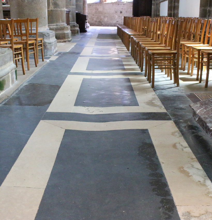 The floor in the cathedral has been worn into a groove by thousands of feet over the years.