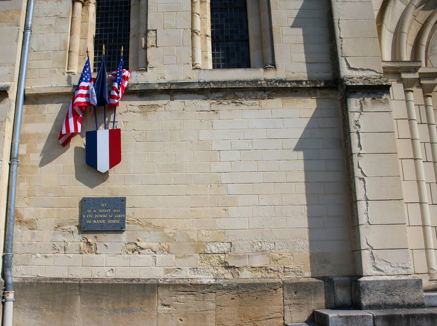 The flags mark the spot where Major Thomas Howie's body was laid on the rubble of L'eglise Sainte-Croix in St. Lo. You can also see the line where the destruction began and ended.