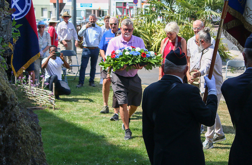 Dave Nore prepares to lay a wreath during Liberation Day ceremonies July 18 in St. Lo. He was assisted by Tom and Jeannie Gee and Jeff and Trudy Hines.