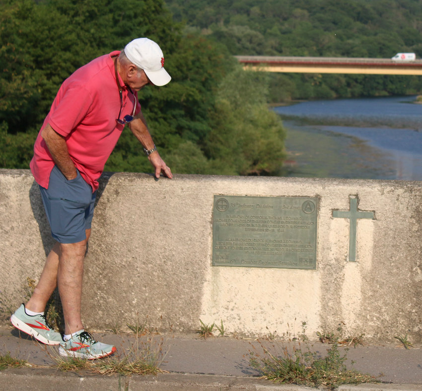 Tom Gee checks out the plaque on the west side of the Flavigny Bridge.