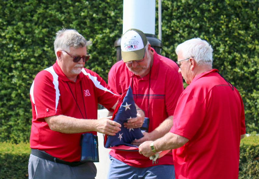 We were allowed to lower the flags for the close of the day at Luxembourg American Cemetery. From left, Dave Nore, Jerry Meyer and Alan Baldwin fold one.