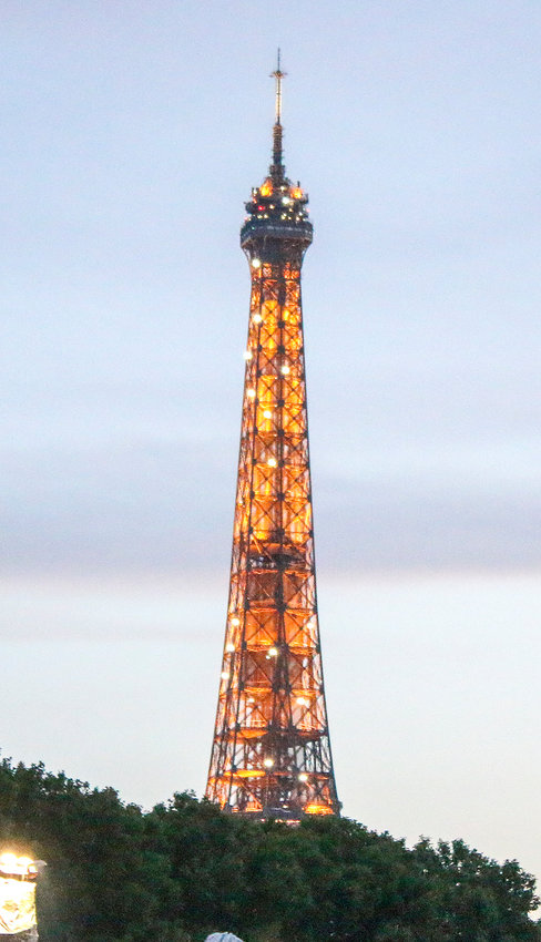 The Eiffel Tower lit up for several minutes with twinkle lights as we cruised along the Seine River July 23.