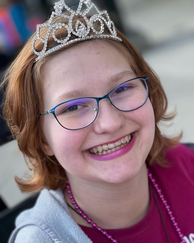Abi Smith smiles in her crown after winning the title of Junior Teen Queen at the Nebraska Miss Amazing pageant.