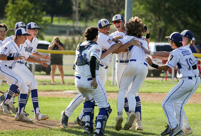 Members of the Malcolm junior legion baseball team celebrate after winning the Class C state championship July 22.
