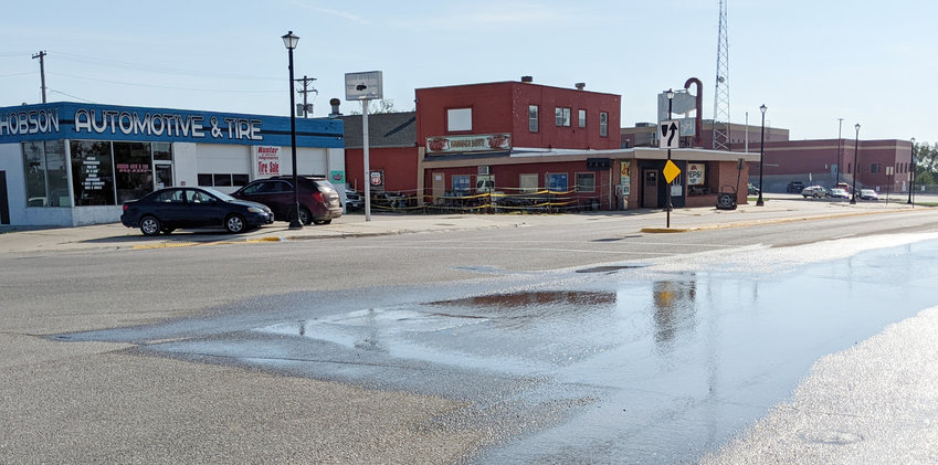 Water seeps up through a broken valve at the intersection of Highway 34 and Seventh Street in Seward. High temperatures have caused concrete to buckle, rupturing some valves and water mains.