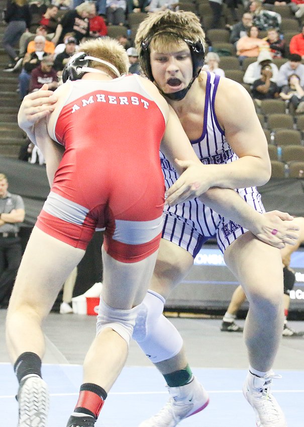 Hunter Oborny of Milford looks for an opening against Brody Bogard of Amherst during their third-place match Feb. 18.