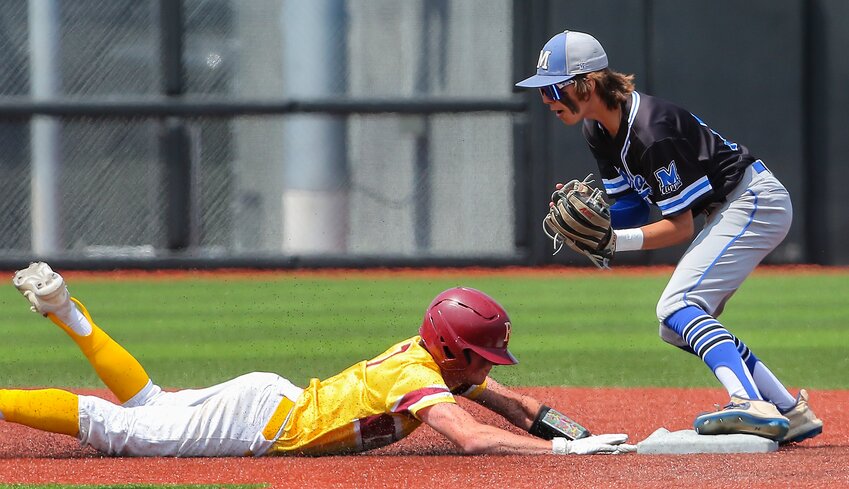 Malcolm second baseman Cody Sykes completes a bang-bang double play, taking a throw from third baseman Mason Wiesnieski after he snared a hard hit line drive off of a Roncalli bat.