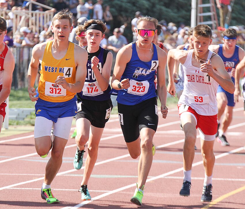 Avery Carter of Milford is squeezed out of line at the start of the 1,600 May 20 by, from left, Drew Martin of West Holt, Dyami Berridge of Winnebago and Carson Noecker of Cedar Catholic, the eventual race champion.