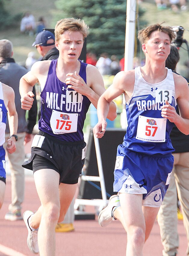 Gavin Dunlap of Milford keeps pace with Centennial's Clinton Turnbull in the 3,200-meter run May 19.