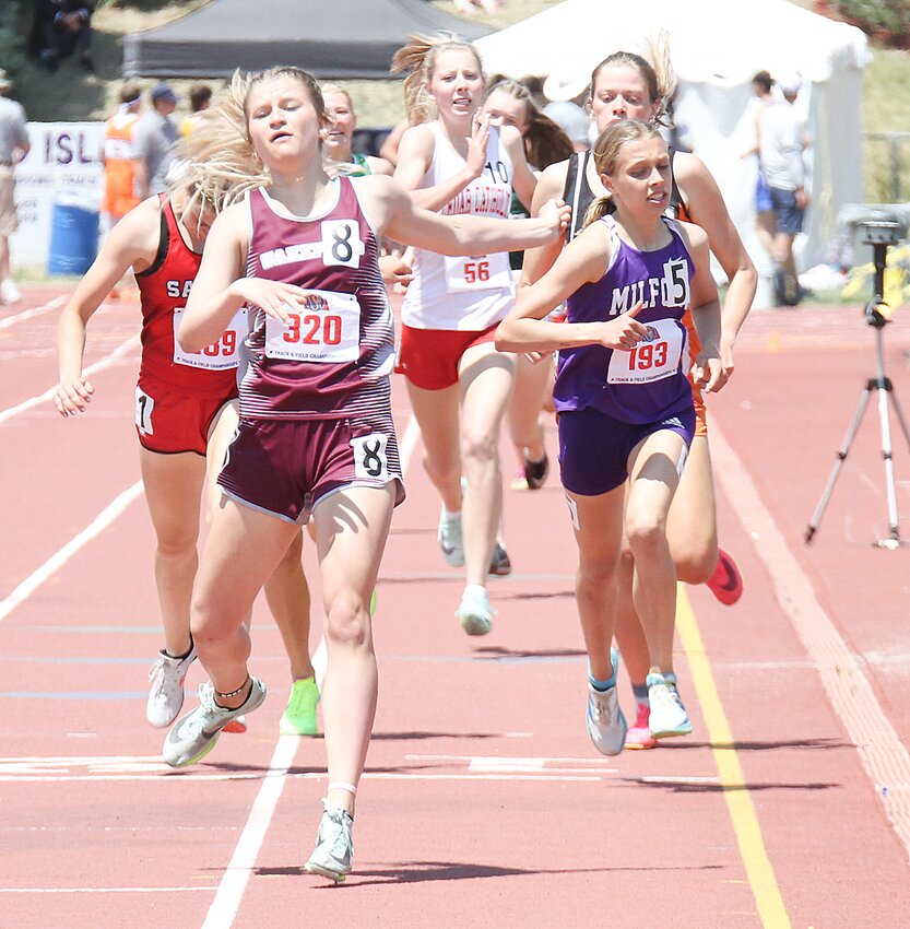 Lilly Kenning leans for the finish line in the 800-meter run behind Jordan Metzler of Wakefield, the event champion. Kenning was second in the 800-, 1,600- and 3,200-meter runs.