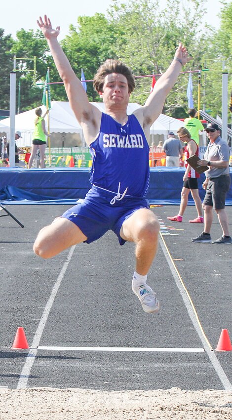 Caden Brooks of Seward soars to the sand in the Class B long jump May 18.
