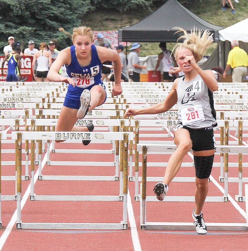 Kelsey Miller of Seward clears the final hurdle in the 100-meter hurdle finals May 18. She was the event runner-up.