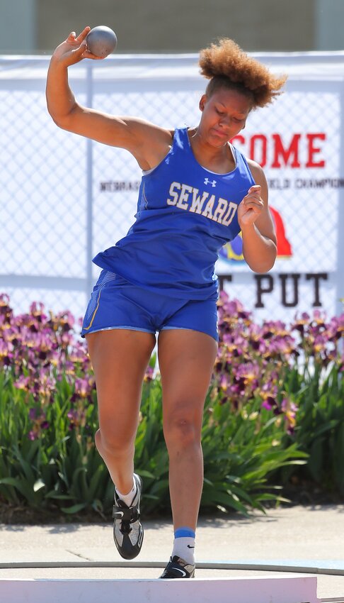 Seward's Lovely Hibbert unleashes a throw in the Class B girls shot put competition May 18.