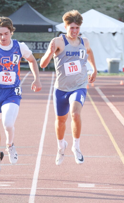 Malcolm's Jonathan Cook leans for the finish in the 200-meter dash May 19 at state track.