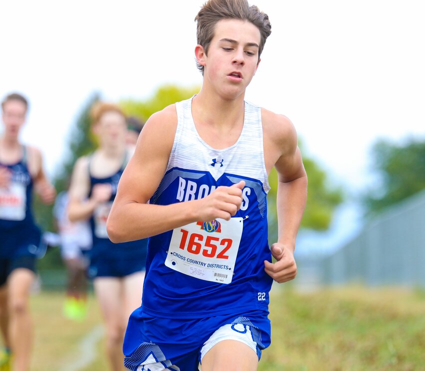 Camden Winkelman of Centennial focuses on rounding the corner at the D1 district cross country meet in Weeping Water on Oct. 12.