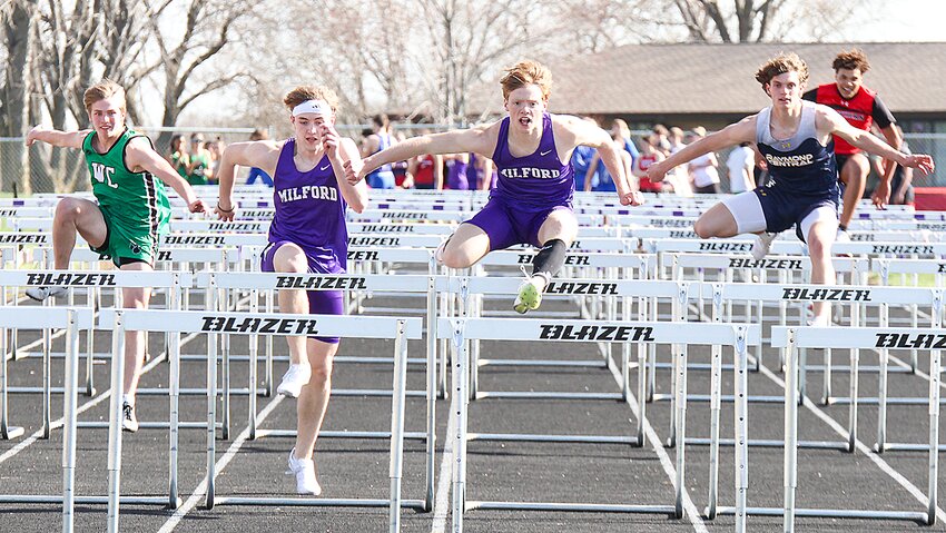 Isaac Roth, right, and Gavin Piening of Milford race to the finish of the 110-meter hurdles April 9.