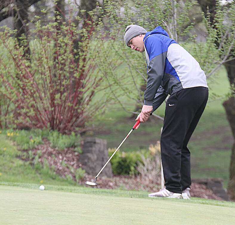 Centennial's Alex Hirschfeld watches his putt on the eighth green at College Heights Country Club April 26.