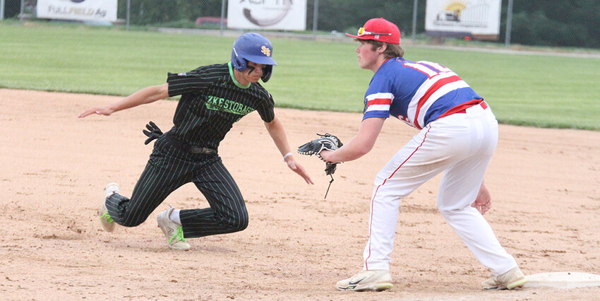 Reggie Sukup of Seward scrambles back to first ahead of the pick-off throw to Crete first baseman Cole Stutzman June 19.