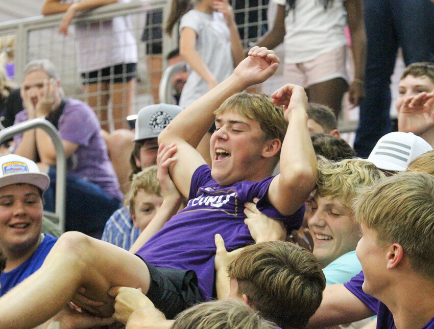 Milford students send Quinn Zegers to the top of the student section and back during the Milford/Seward volleyball match Aug. 29.