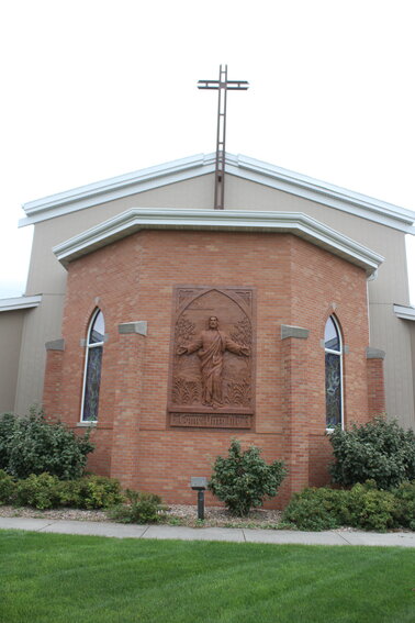 The Image of Bricks on the northwest side of St. Paul Lutheran Church in Utica depicts Jesus with His arms outstretched and the words “come unto Me.”