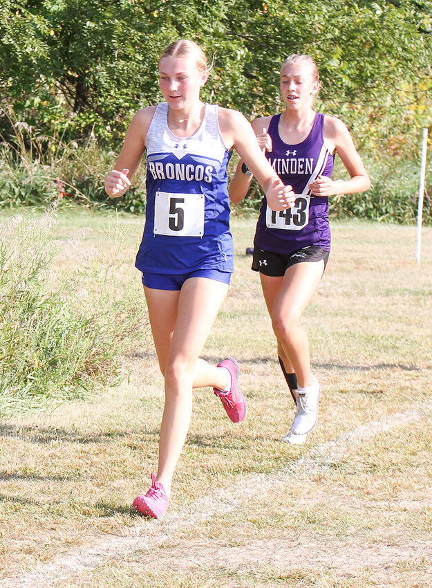 Grace Schernikau of Centennial gets around at Minden runner at the Milford Invite Sept. 12. Schernikau finished third overall.