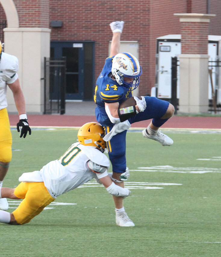 Seward's Ed Knott tries to skip out of a Pius X tackle Sept. 13 in Seward's 35-0 win over the Thunderbolts.