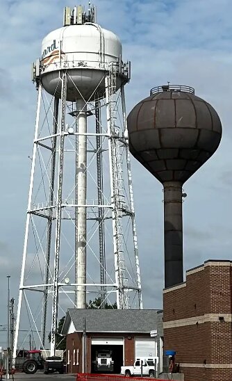 The new water tower, right, looks shorter than the old one, but City Administrator Greg Butcher said it is the water level inside that impacts water pressure, not the exterior height. 