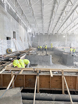 Workers make advances on the construction of the pool at the Seward Wellness Center. 