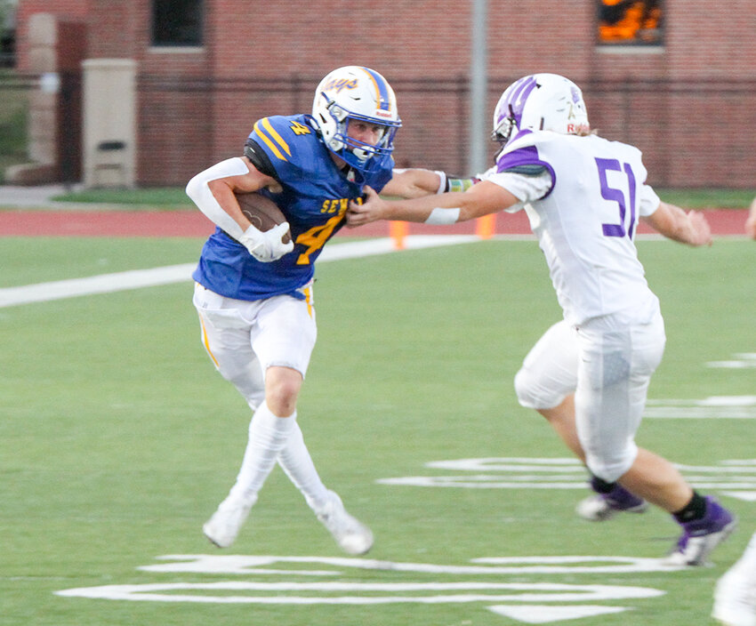 Peyton Else of Seward stiffarms a Lincoln Northwest defender on the way to the endzone during Seward's 41-6 homecoming win over the Falcons Friday night.