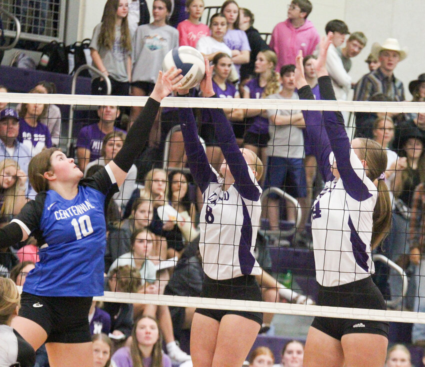 Tyler Opfer of Centennial tries to get around the block by Milford's Kylie Jakub and Ashlynn Miller Oct. 1.