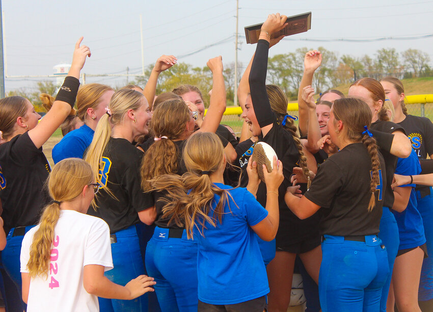 The Seward softball team celebrates a district championship on Oct. 11.