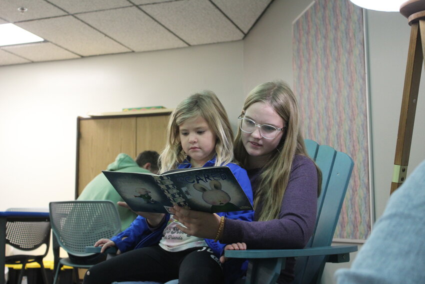 Addison Petzoldt reads to Melody Waller during Centennial’s Kick Off With a Good Book Oct. 3.