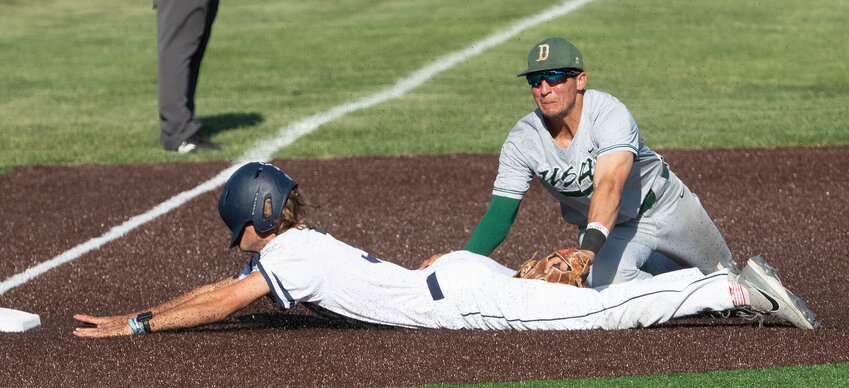 Concordia's Zackery Day slides into third on a sacrifice fly before scoring the winning run on teammate Michael Welch's sacrifice fly in the bottom of the ninth inning in the Bulldogs' 5-4 victory over the University of Science and Arts of Oklahoma in the opening round of the NAIA postseason tournament.