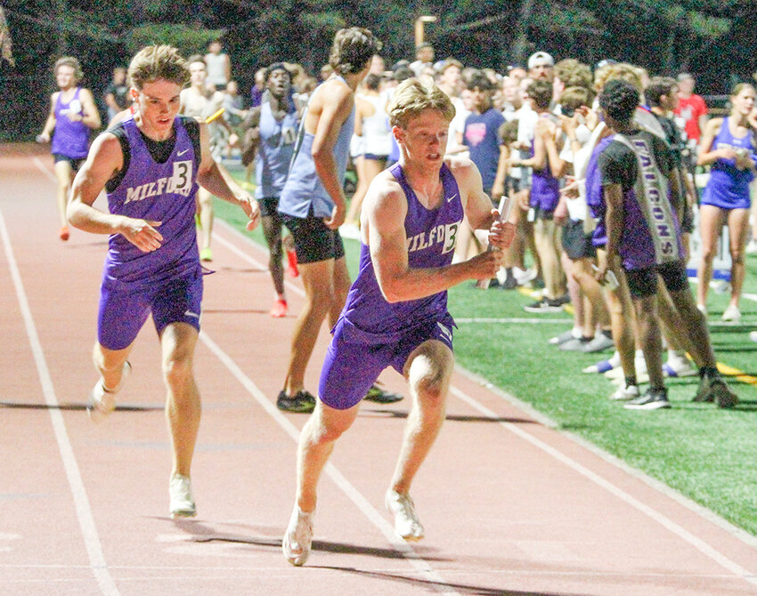 Isaac Roth takes the baton from Zeb Reil in the 4x400-meter relay at districts yesterday. The Eagles finished third in the event and qualified for state based on their time, which was 3:26.19.