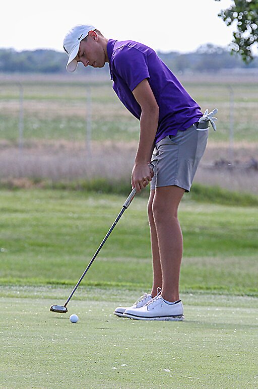 Zephyr Mowinkel watches his final putt on the 18th green May 29 at the Class C state golf tournament.