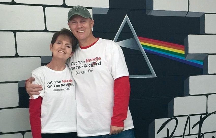 Karen and Casey Sorensen-Kindt post in front of their Pink Floyd mural, at the former brick and mortar location of Put The Needle On The Record in Duncan, Okla. The couple moved to Seward in December, and have continued to sell records online..Photo Courtesy of Karen Sorensen-Kindt