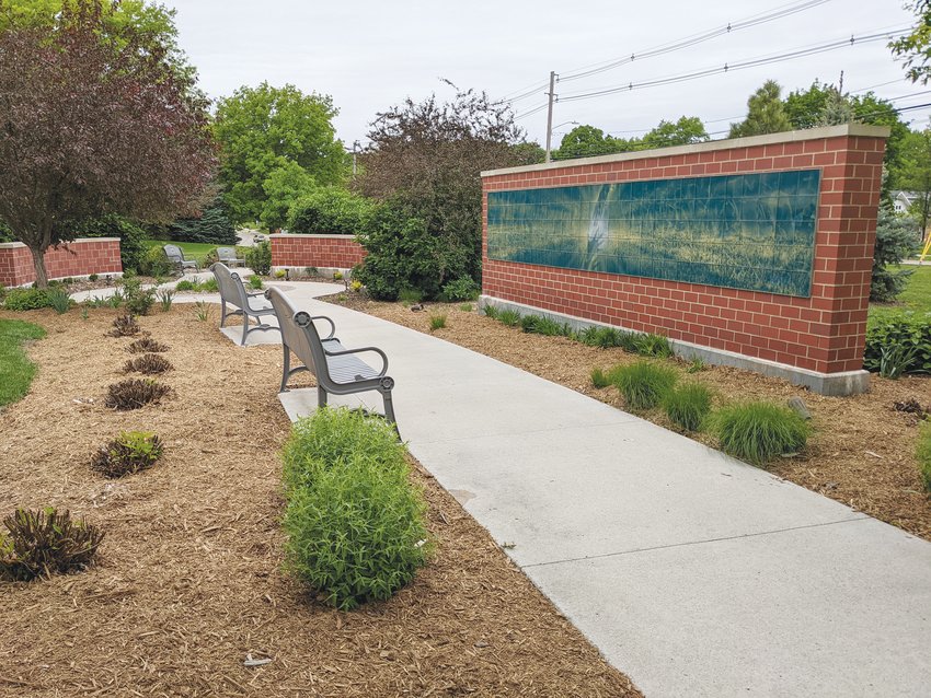 The optically animated Lifetile wall in the Heartfelt Children&rsquo;s Memorial garden depicts a boy and girl running through a meadow surrounded by butterflies.