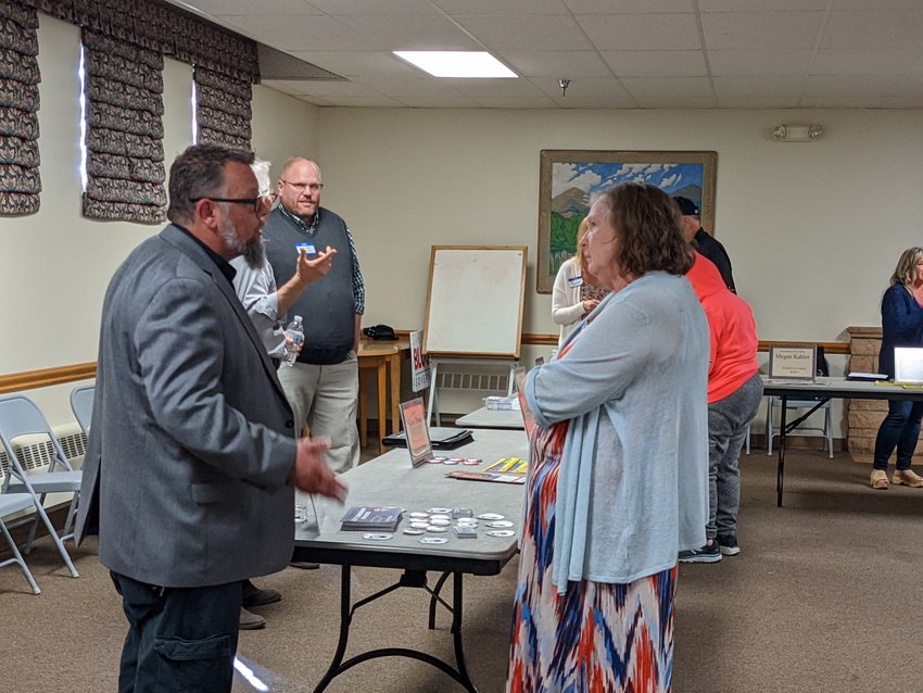 Laurie Baack, right, visits with Libertarian candidate for governor Scott Zimmerman at the Seward County League of Women Voters Candidates Night Sept. 25.