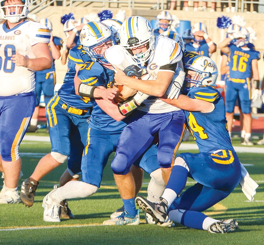Seward's AJ Frazey (51) and Jackson Anderson (34) team up to bring down the Gering ball carrier Sept. 23.