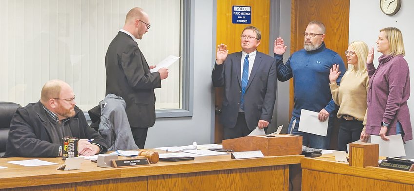 Seward City Clerk Derek Bargmann administers the Oath of Office Dec. 6 to new and re-elected council members (from left) Rich Wergin, Karl Miller, Tatum Tonniges and Megan Kahler. Josh Eickmeier (far left) was sworn in for another four-year term as mayor.