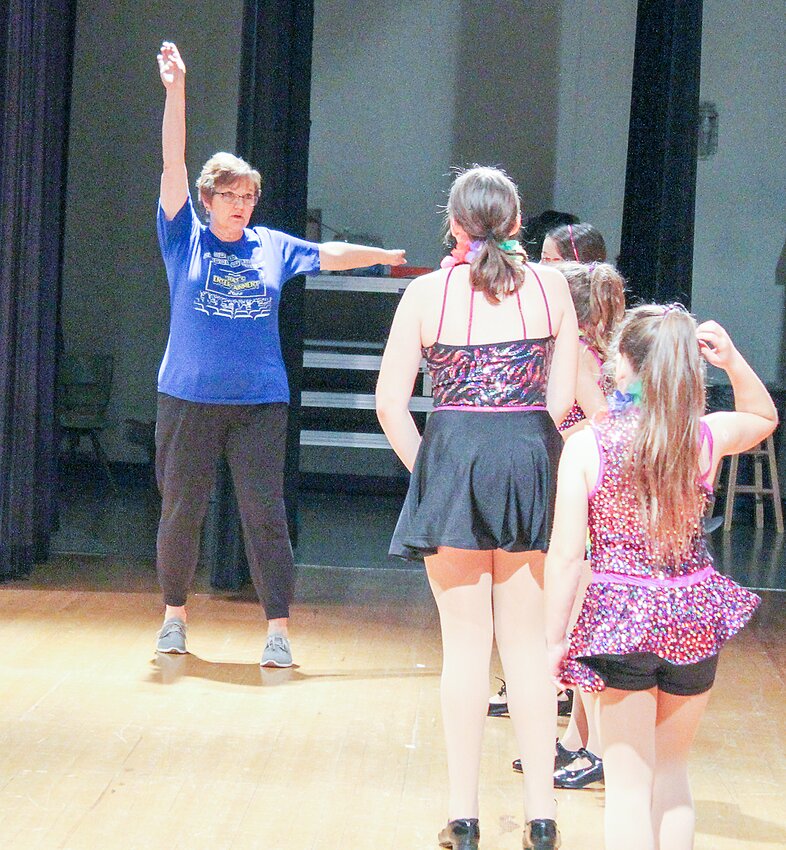 Shelly Smetter demonstrates proper arm position to one of the tap classes during the rehearsal for the 2023 recital.