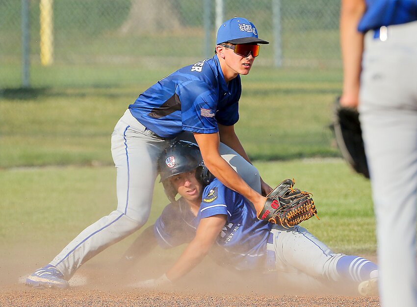 UBCF's Jacob Weber and Malcolm's Cole Tiedeman look for the call during a close play at third in junior legion action May 26.